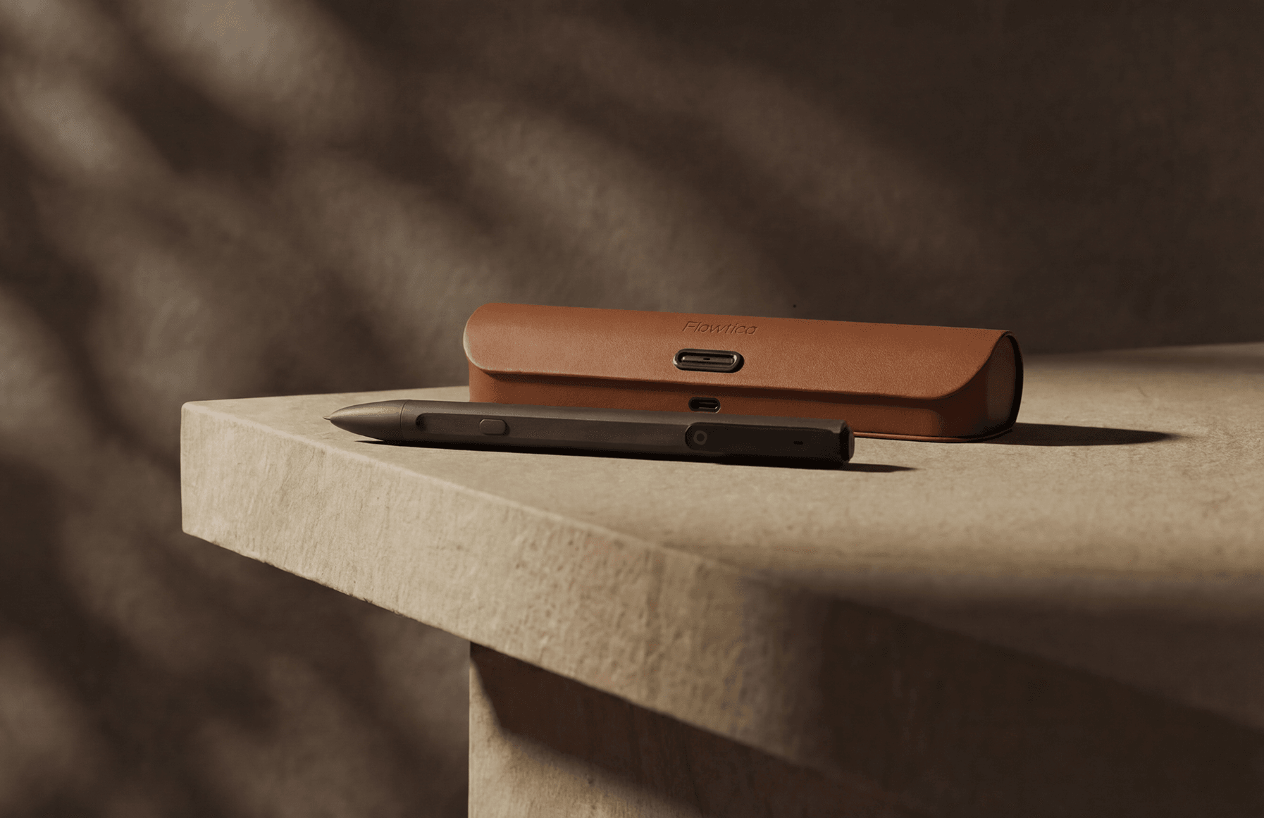 Flowtica Scribe pen and leather case on a stone desk